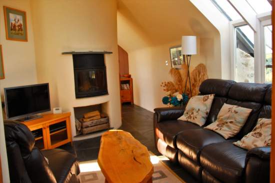 Snug upstairs lounge with log burning stove and views across the Gwaun Valley and Dinas Mountain